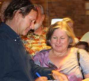 Peter autographs his new book.