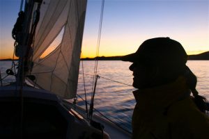 Sheila Reed silhouetted at sunset during the Governor's Cup. Photo: Chris Smith